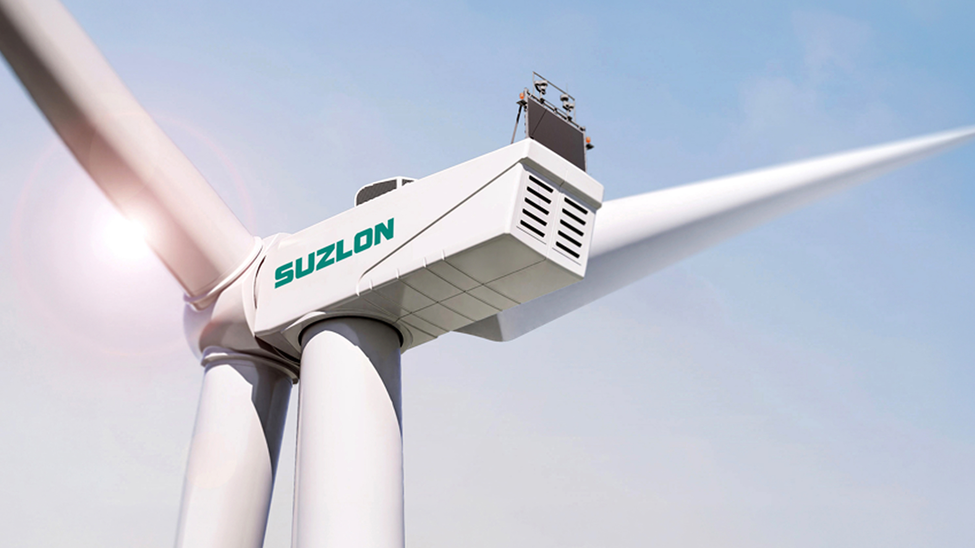 Suzlon wind turbine nacelle aerial view over green fields